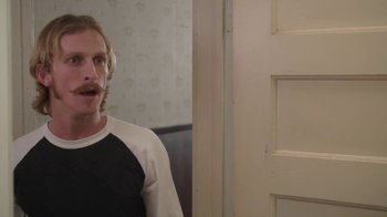 Movie still from “Everybody Wants Some!!” (2016), directed by Richard Linklater – A man standing in front of a door and looking surprised; Close Up shot, Over the shoulder angle