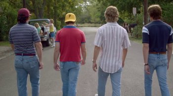 Movie still from “Everybody Wants Some!!” (2016), directed by Richard Linklater – A couple of people that are standing in the street; Medium shot, Over the shoulder angle