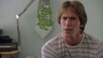 Movie still from “Everybody Wants Some!!” (2016), directed by Richard Linklater – A young man is sitting in front of a green and white floral tie; Close Up shot, Over the shoulder angle