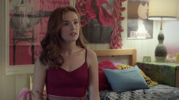 Movie still from “Everybody Wants Some!!” (2016), directed by Richard Linklater – A beautiful young lady standing in front of a bed in a bedroom; Medium shot, Over the shoulder angle