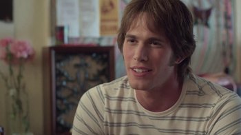 Movie still from “Everybody Wants Some!!” (2016), directed by Richard Linklater – A young man sitting at a table in a room; Close Up shot, Over the shoulder angle