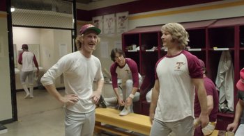 Movie still from “Everybody Wants Some!!” (2016), directed by Richard Linklater – A group of young men standing next to each other in a locker room; Medium shot, Over the shoulder angle