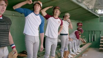 Movie still from “Everybody Wants Some!!” (2016), directed by Richard Linklater – A group of baseball players standing in a dugout; Medium shot, Over the shoulder angle