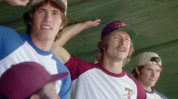 Movie still from “Everybody Wants Some!!” (2016), directed by Richard Linklater – A group of young men standing next to each other on a field; Medium shot, Over the shoulder angle