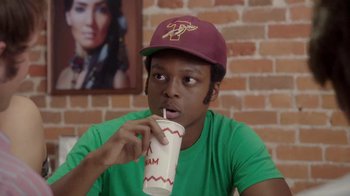 Movie still from “Everybody Wants Some!!” (2016), directed by Richard Linklater – A young man drinking from a paper cup with a straw; Close Up shot, Over the shoulder angle