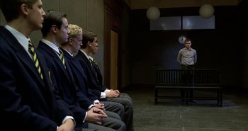 Movie still from “Evil” (2003), directed by Mikael Håfström – A group of young men sitting on a bench; Wide shot, Over the shoulder angle