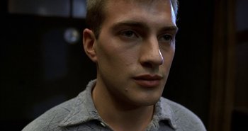 Movie still from “Evil” (2003), directed by Mikael Håfström – A man's face in a gray shirt; Close Up shot, High angle