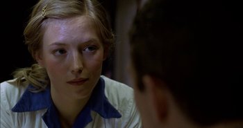 Movie still from “Evil” (2003), directed by Mikael Håfström – A woman sitting in front of a mirror looking at a man; Close Up shot, Over the shoulder angle