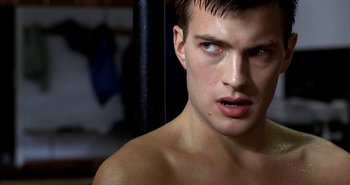 Movie still from “Evil” (2003), directed by Mikael Håfström – A man's face in a dark room; Close Up shot, Over the shoulder angle