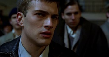 Movie still from “Evil” (2003), directed by Mikael Håfström – A person wearing a suit and tie; Close Up shot, Over the shoulder angle