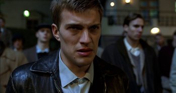 Movie still from “Evil” (2003), directed by Mikael Håfström – A person wearing a leather jacket; Close Up shot, Low angle