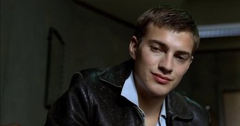 Movie still from “Evil” (2003), directed by Mikael Håfström – A young man in a leather jacket looking at the camera; Close Up shot, Low angle