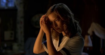 Movie still from “Evil” (2003), directed by Mikael Håfström – A girl is holding her hand to her face; Close Up shot, Over the shoulder angle