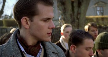 Movie still from “Evil” (2003), directed by Mikael Håfström – A person wearing a suit and tie; Close Up shot, Over the shoulder angle