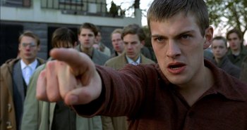 Movie still from “Evil” (2003), directed by Mikael Håfström – A group of men standing in front of each other; Close Up shot, Low angle