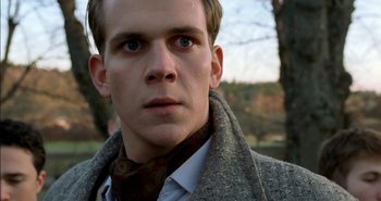 Movie still from “Evil” (2003), directed by Mikael Håfström – A person wearing a coat; Close Up shot, Low angle