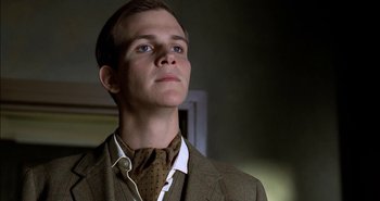 Movie still from “Evil” (2003), directed by Mikael Håfström – A man in a suit and tie looking upward; Close Up shot, Low angle