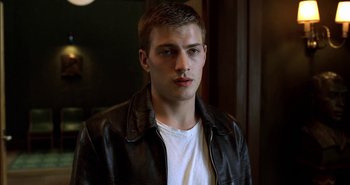 Movie still from “Evil” (2003), directed by Mikael Håfström – A young man wearing a leather jacket and white t - shirt; Close Up shot, Low angle