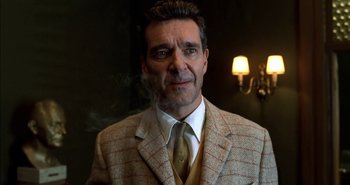 Movie still from “Evil” (2003), directed by Mikael Håfström – A person wearing a suit and tie; Close Up shot, Low angle