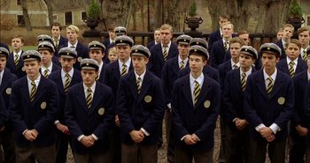 Movie still from “Evil” (2003), directed by Mikael Håfström – A group of young men standing next to each other; Wide shot, High angle