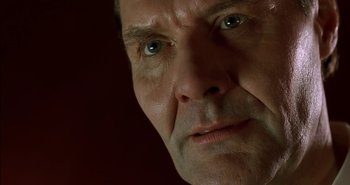 Movie still from “Evil” (2003), directed by Mikael Håfström – A man's face with green eyes; Extreme Close Up shot, Low angle