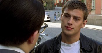 Movie still from “Evil” (2003), directed by Mikael Håfström – A young man talking to another young man on the street; Close Up shot, Over the shoulder angle