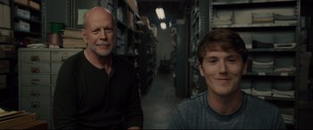 Movie still from “Glass” (2019), directed by M. Night Shyamalan – Two men sitting in a room next to each other; Close Up shot, Over the shoulder angle