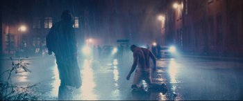 Movie still from “Glass” (2019), directed by M. Night Shyamalan – A man kneeling on the ground in the middle of the night; Wide shot, Low angle