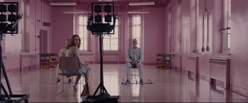 Movie still from “Glass” (2019), directed by M. Night Shyamalan – A man and a woman sitting in front of a video camera; Wide shot, Over the shoulder angle