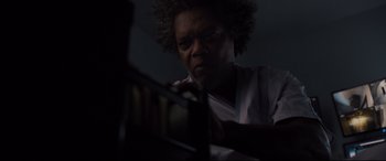 Movie still from “Glass” (2019), directed by M. Night Shyamalan – An older man is looking at a book; Close Up shot, Low angle