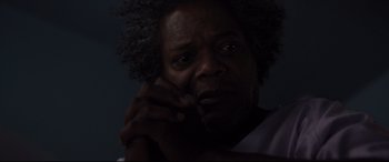 Movie still from “Glass” (2019), directed by M. Night Shyamalan – A person holding his hand up to his face; Close Up shot, Low angle