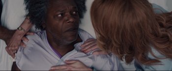 Movie still from “Glass” (2019), directed by M. Night Shyamalan – A man and a woman looking in the same direction in the mirror; Close Up shot, Over the shoulder angle