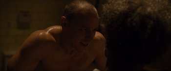 Movie still from “Glass” (2019), directed by M. Night Shyamalan – A man with a shaved head is looking into the camera; Close Up shot, Over the shoulder angle