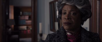 Movie still from “Glass” (2019), directed by M. Night Shyamalan – An older black woman wearing a gray coat; Close Up shot, Over the shoulder angle