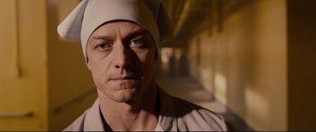 Movie still from “Glass” (2019), directed by M. Night Shyamalan – A person wearing a hat; Close Up shot, Low angle