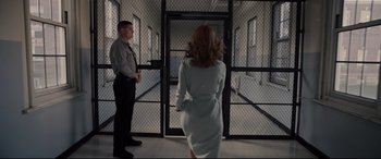 Movie still from “Glass” (2019), directed by M. Night Shyamalan – A woman and a man are standing in front of a door; Wide shot, Over the shoulder angle