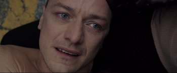 Movie still from “Glass” (2019), directed by M. Night Shyamalan – A man's face with blue eyes; Close Up shot, Over the shoulder angle