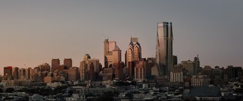 Movie still from “Glass” (2019), directed by M. Night Shyamalan – A view of a city skyline at sunset; Extreme Wide shot, High angle