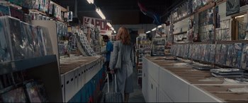 Movie still from “Glass” (2019), directed by M. Night Shyamalan – A woman is walking down the aisle with a suitcase; Wide shot, Low angle