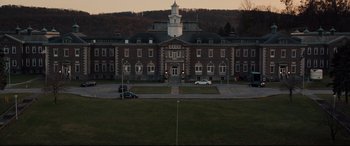 Movie still from “Glass” (2019), directed by M. Night Shyamalan – A building that is very large and has many windows on it; Extreme Wide shot, High angle