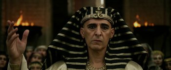 Movie still from “Exodus: Gods and Kings” (2014), directed by Ridley Scott – A man wearing a black and gold headdress; Close Up shot, Low angle