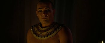 Movie still from “Exodus: Gods and Kings” (2014), directed by Ridley Scott – A man wearing a necklace of gold and red beads; Close Up shot, Over the shoulder angle