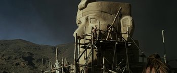 Movie still from “Exodus: Gods and Kings” (2014), directed by Ridley Scott – Two men working on the face of an egyptian statue; Extreme Wide shot, Low angle
