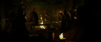 Movie still from “Exodus: Gods and Kings” (2014), directed by Ridley Scott – A group of people sitting around a fire; Wide shot, High angle