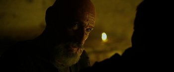 Movie still from “Exodus: Gods and Kings” (2014), directed by Ridley Scott – A man with a shaved head and a goatee; Close Up shot, Over the shoulder angle