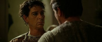 Movie still from “Exodus: Gods and Kings” (2014), directed by Ridley Scott – A man in chains talking to another man in chains; Close Up shot, Over the shoulder angle