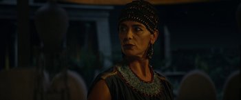 Movie still from “Exodus: Gods and Kings” (2014), directed by Ridley Scott – An older woman wearing an egyptian headdress; Close Up shot, Over the shoulder angle