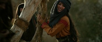 Movie still from “Exodus: Gods and Kings” (2014), directed by Ridley Scott – A woman in a turban is holding a tree branch; Medium shot, Over the shoulder angle