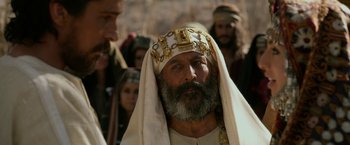 Movie still from “Exodus: Gods and Kings” (2014), directed by Ridley Scott – A man with a beard wearing a crown; Close Up shot, Over the shoulder angle