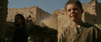 Movie still from “Exodus: Gods and Kings” (2014), directed by Ridley Scott – A young boy standing in front of a mountain; Close Up shot, Low angle